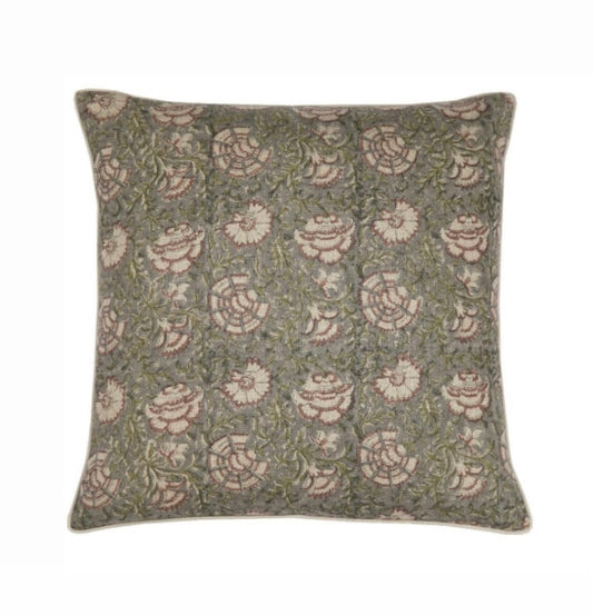 Block print pillow cover with flowers on green background.
