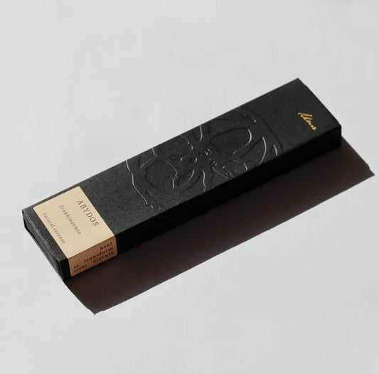 A black box of Abydos incense with embossed designs, featuring Japanese style incense sticks.