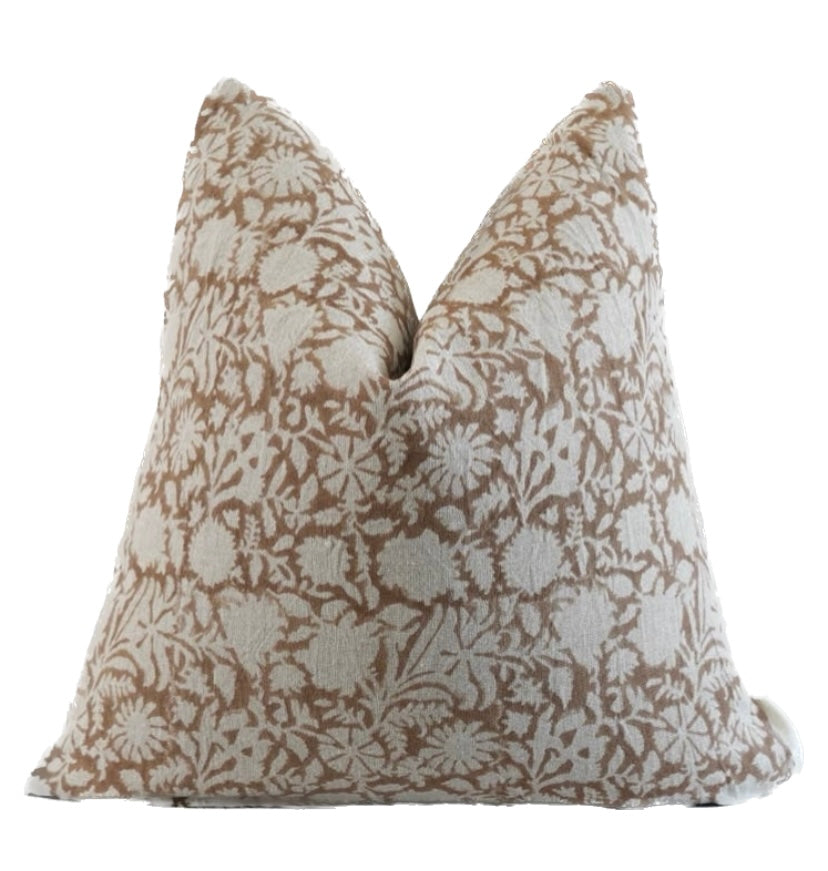 A beige hand blocked linen pillow cover with a floral pattern and a zipper closure.