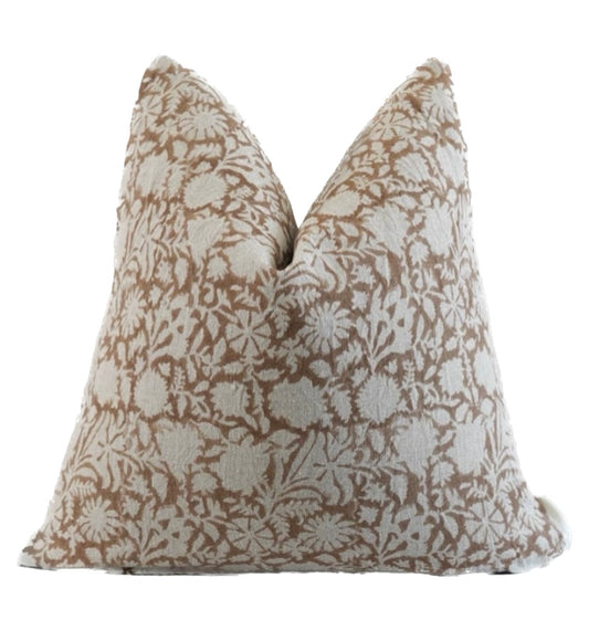 A beige hand blocked linen pillow cover with a floral pattern and a zipper closure.