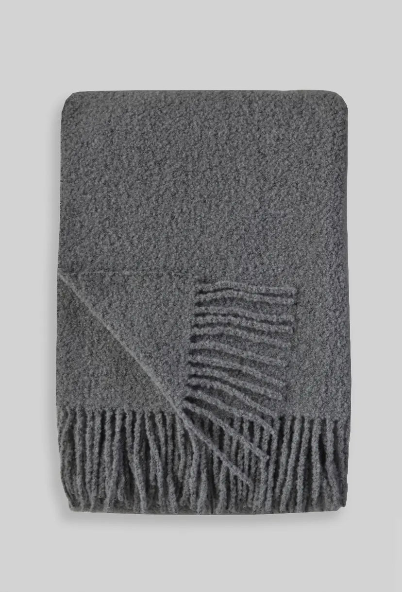Gray boucle throw blanket with fringe.