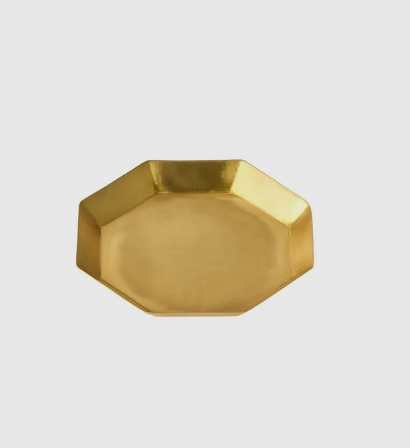 Close-up of brass octagonal plate.
