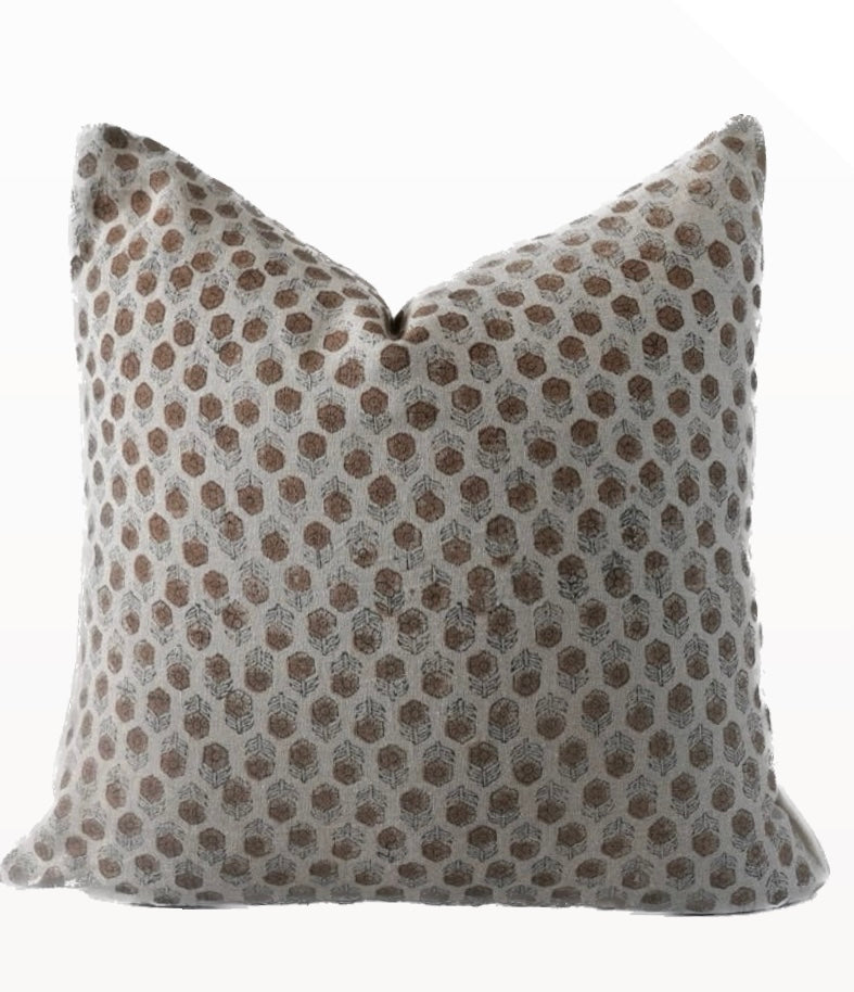 A beige and brown geometric patterned pillow cover with a zipper closure.