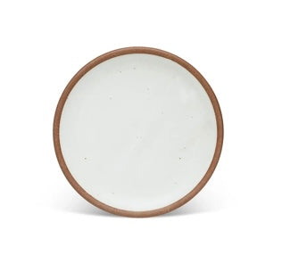 An eggshell dinner plate with a brown rim form East Fork