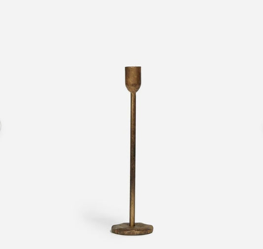 A single taper candle holder with a distressed antique brass finish on a white background.