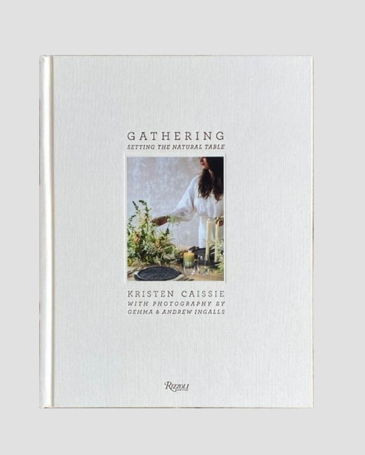 A book titled 'Gathering' by Kristen Caissie with a photograph of a table setting with flowers and a candle on the cover.
