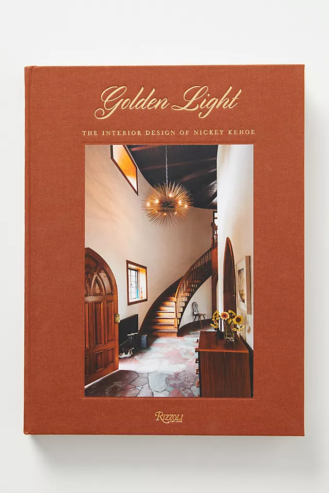 A book titled 'Golden Light' by Nickey Kehoe featuring an interior design portfolio, with a photograph of a staircase on the cover.