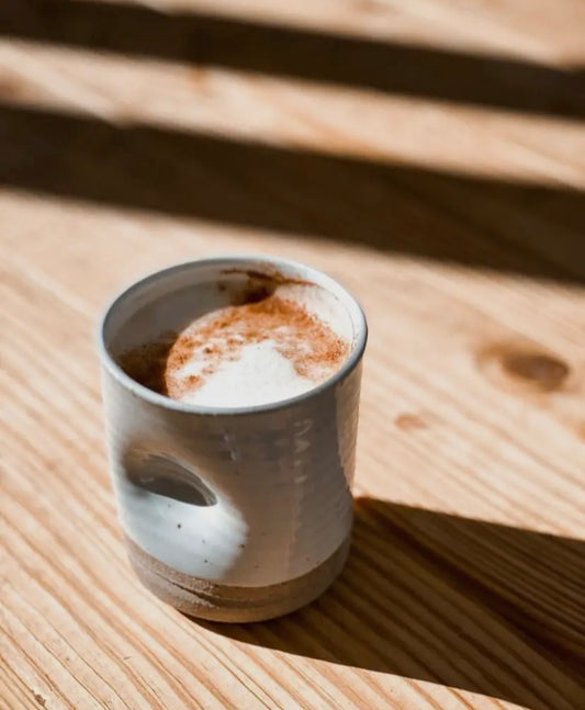 Close-up of hand-thrown thumb cup, 12 oz, with smooth curve for grip.
