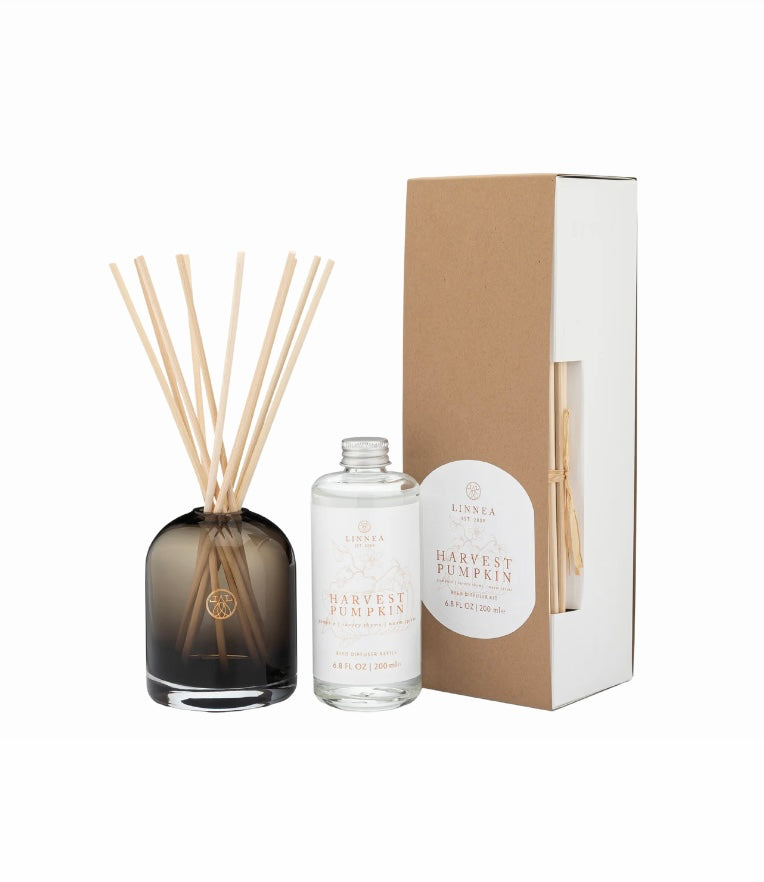Harvest Pumpkin diffuser set with bottle, sticks, and packaging on a white background