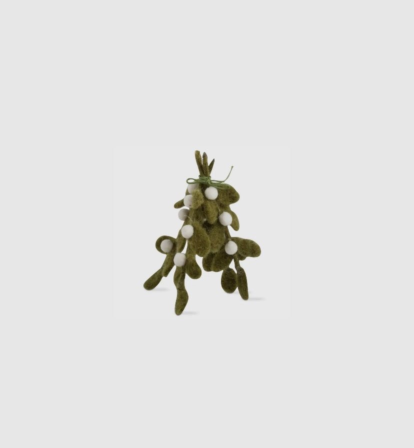 Decorative green mistletoe with white berries on a light gray background