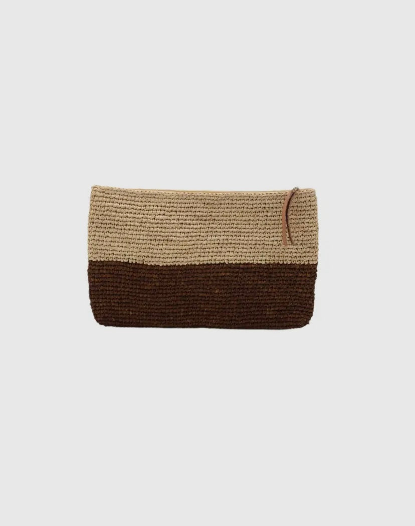 A woven raffia clutch with zipper closure, featuring a two-tone design with a darker color on the lower half and a lighter color on the upper half.