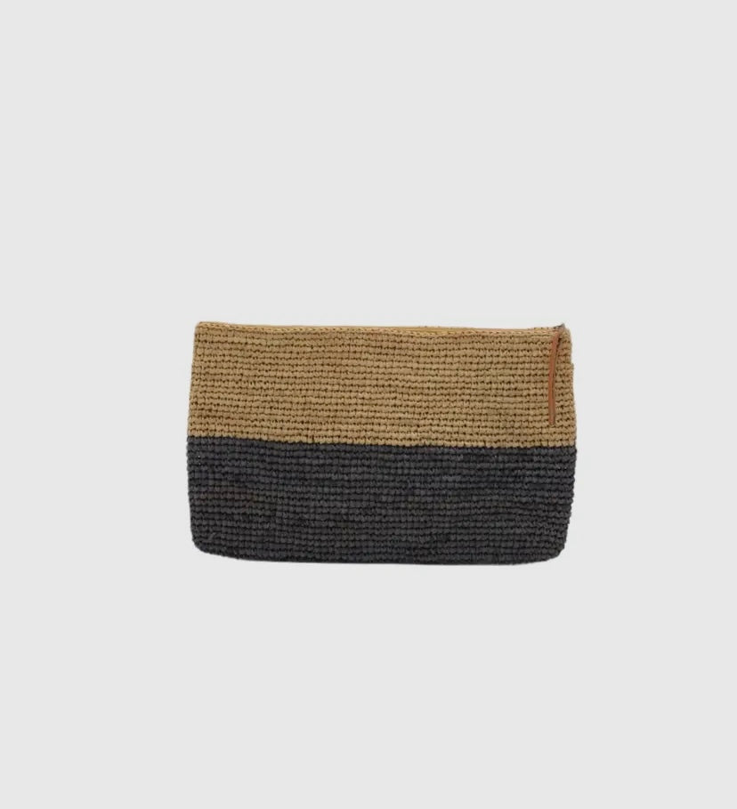 A woven raffia clutch with zipper closure, featuring a two-tone design with a darker color on the lower half and a lighter color on the upper half.