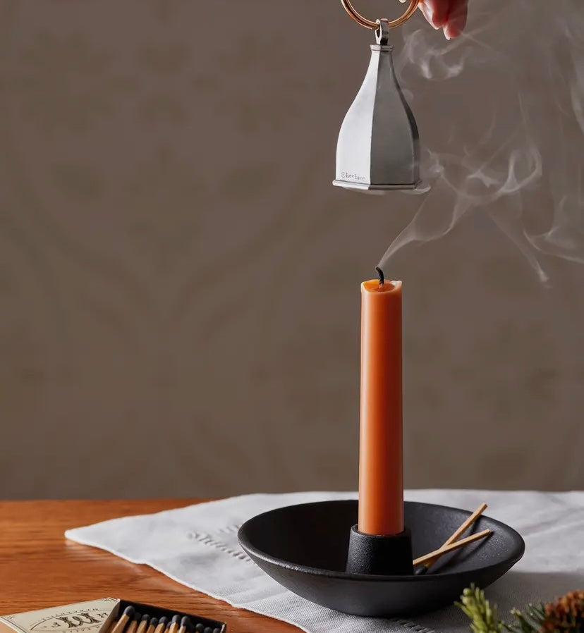 Pewter Candle Snuffer in use.