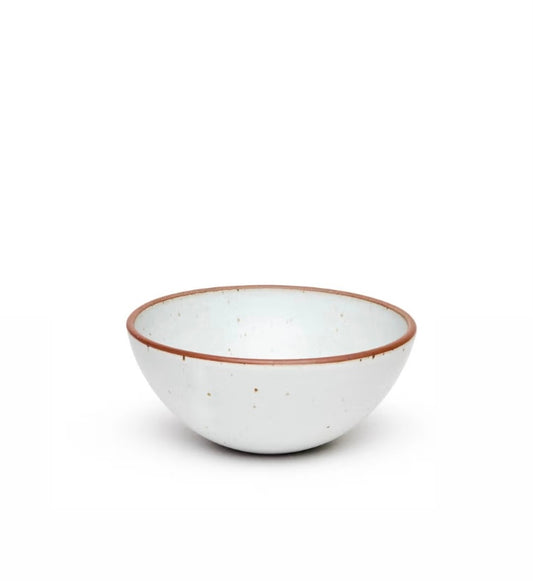 A white stoneware popcorn bowl  from East Fork with a brown rim, isolated on a white background.