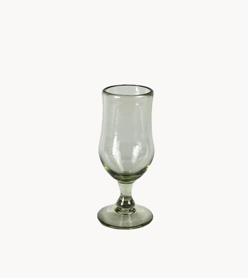 Clear tulip shaped handblown glass on a white background