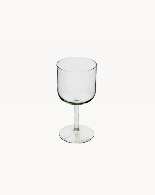 A clear handblown glass wine glass from the Kingdom of Swaziland with a stem, suitable for serving wine or cocktails.