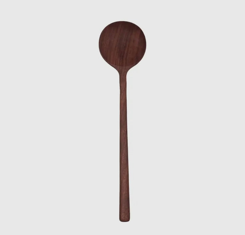 A handmade walnut wooden spoon with a round bowl and a long handle.