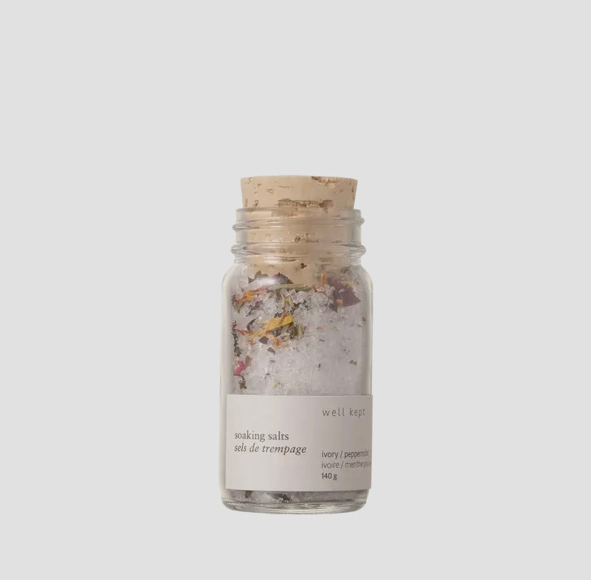 A clear glass jar with a beige lid, labeled 'SOAKING SALTS ivory/peppermint' and 'Natural Ingredients Made in Canada'.