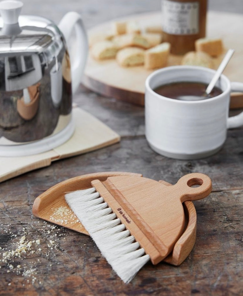 Table brush pictured on table with coffee.