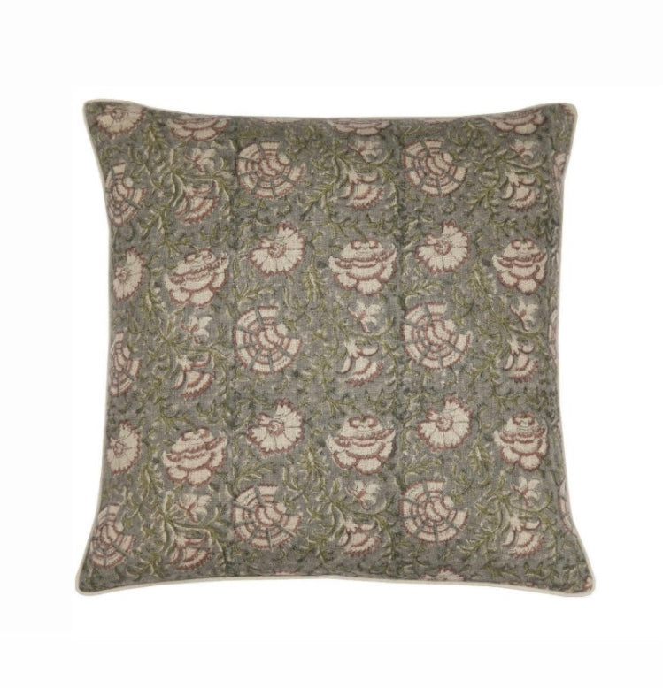 Block print pillow cover with flowers on green background.