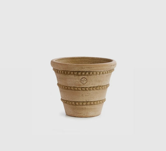 A beige, round ceramic pot with triple beaded detailing, designed by Peter Wakefield.