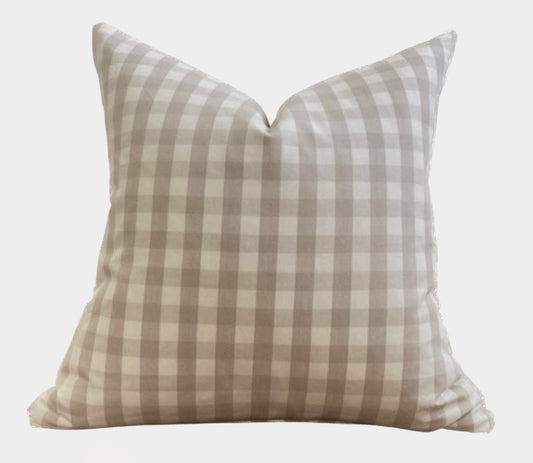 A square linen check pillow cover in beige and ivory, showing a double-sided pattern with checks on both sides.