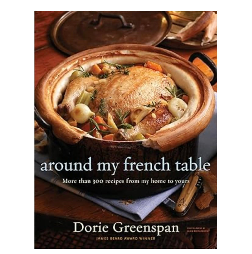 Book cover of 'Around My French Table' by Dorie Greenspan with a dish in a pot on a wooden table.