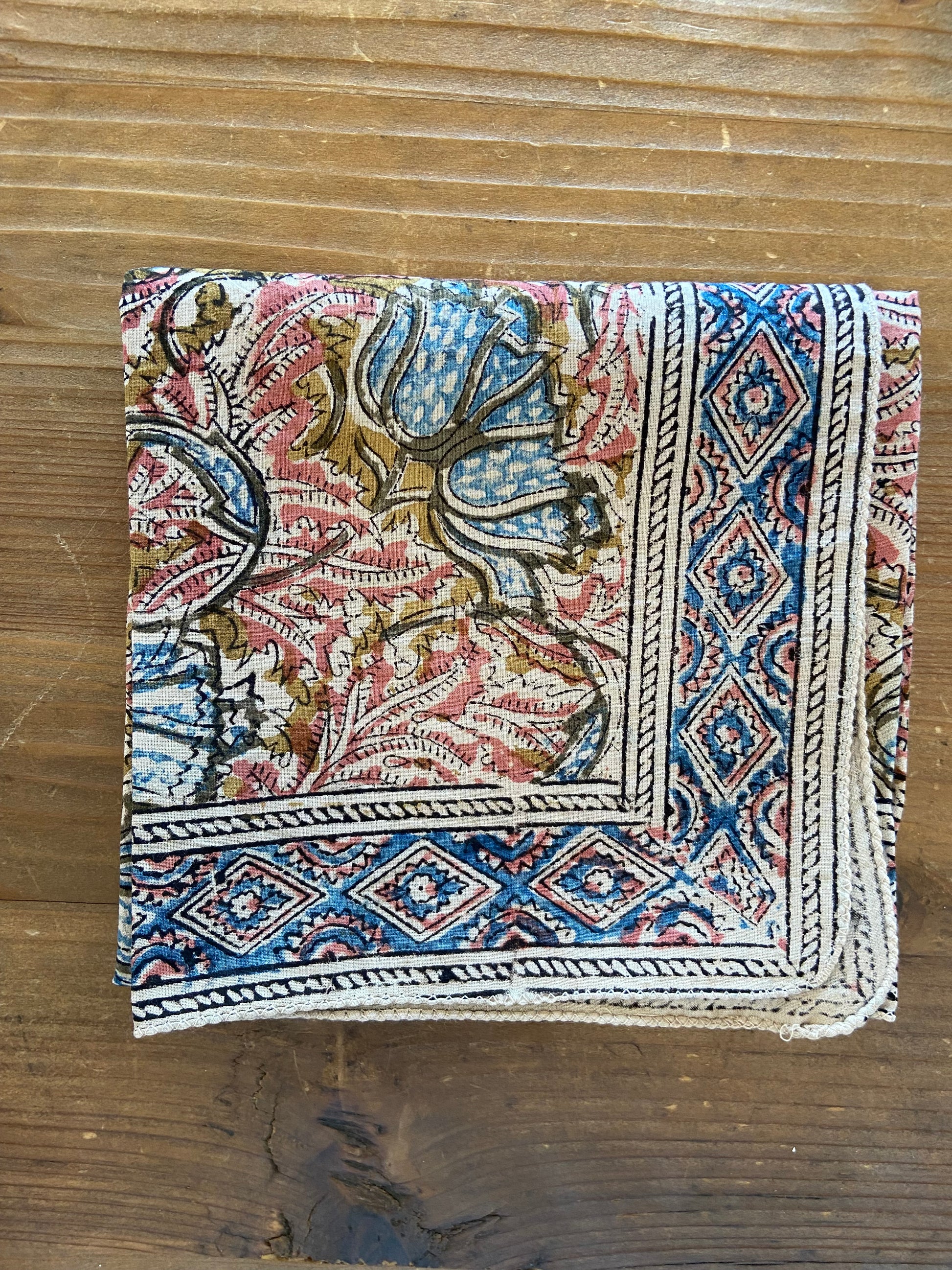 Decorative bandana with intricate patterns on a wooden surface