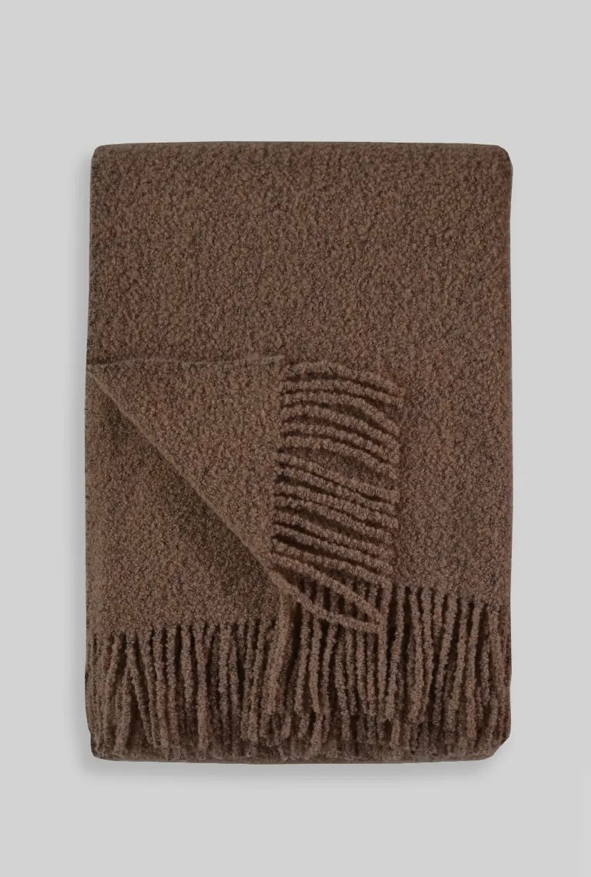 Brown textured blanket with geometric pattern on a light gray background