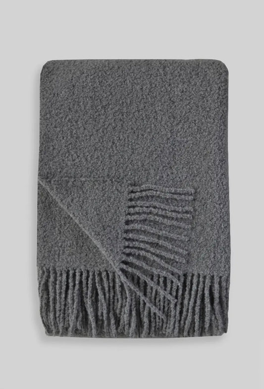 Gray boucle throw blanket with fringe.