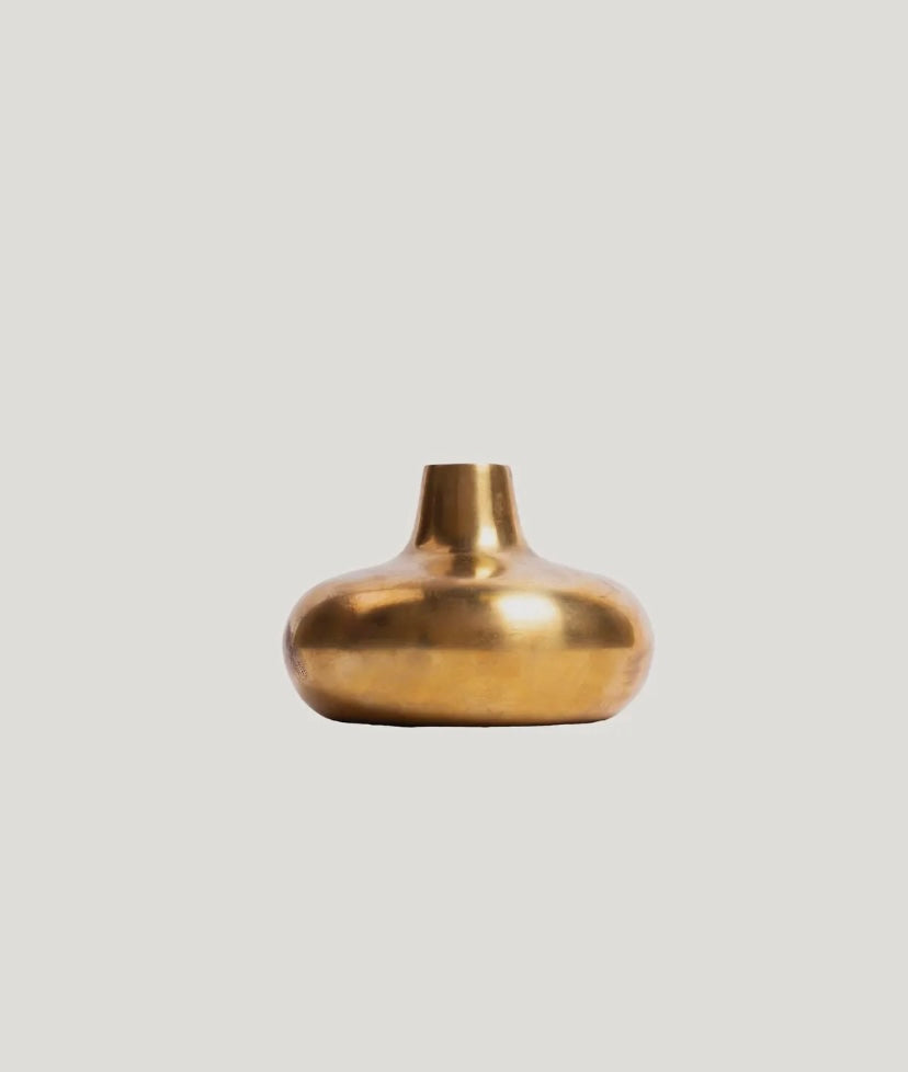 Gold vase on a light gray background