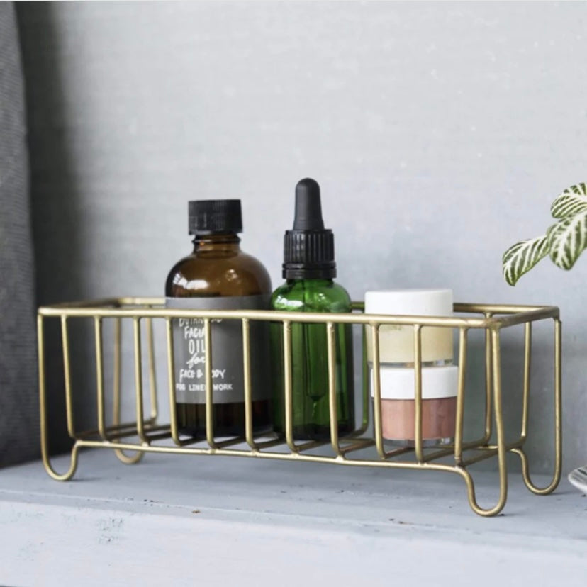 Brass wire basket styled with bath products.