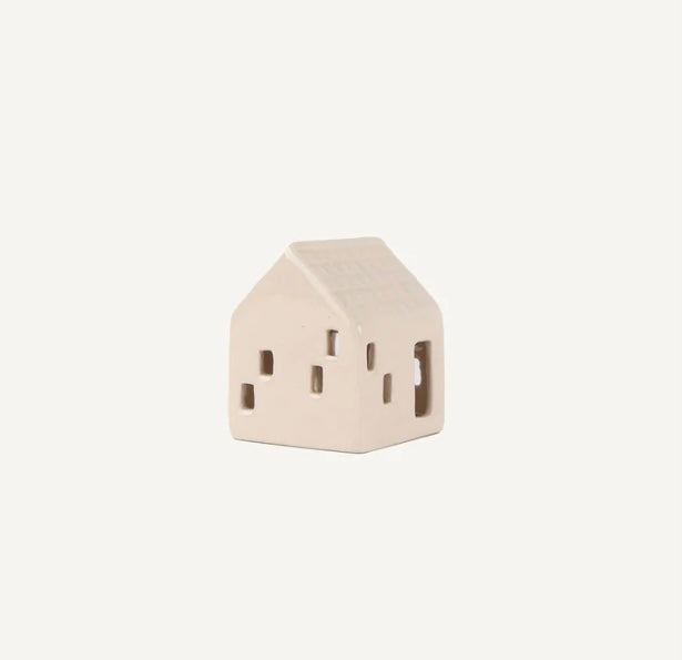 Small beige ceramic house-shaped object on a white background