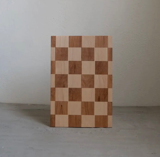 A handmade hickory butcher block in a checkerboard pattern, displayed vertically.