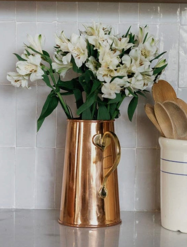 Coper pitcher used to style daffodils.