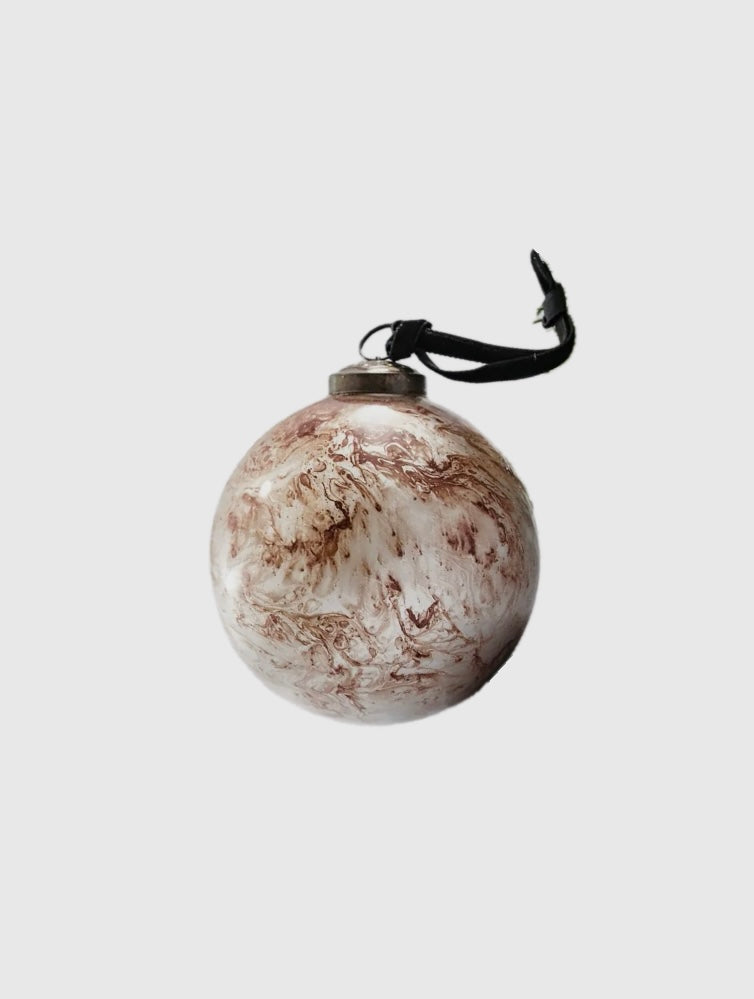 Marble-textured round ornament with a black string on a light gray background