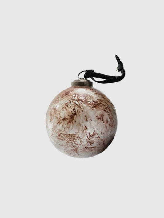 Marble-textured round ornament with a black string on a light gray background