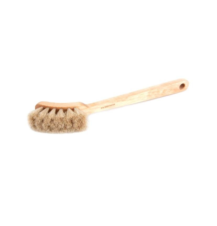 Bristle brush with wooden handle on a white background by iris hantverk