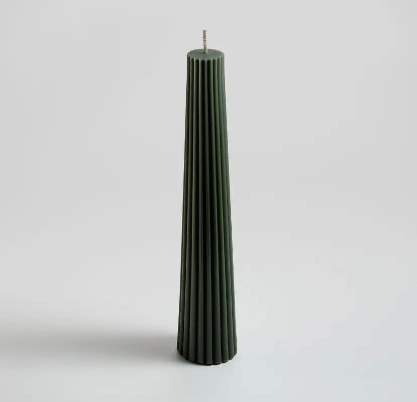 A tall fluted pillar candle made of pure North American beeswax, with an antique tint, hand-poured and finished, displayed against a plain background.
