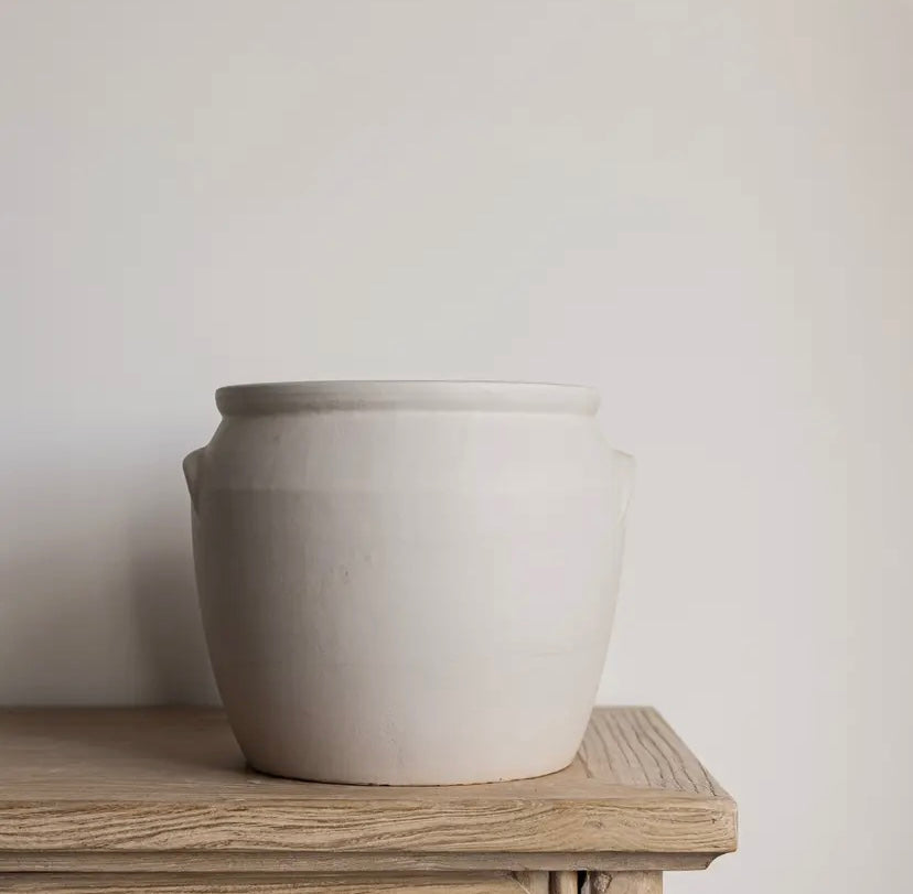 White ceramic confit pot on a wooden table