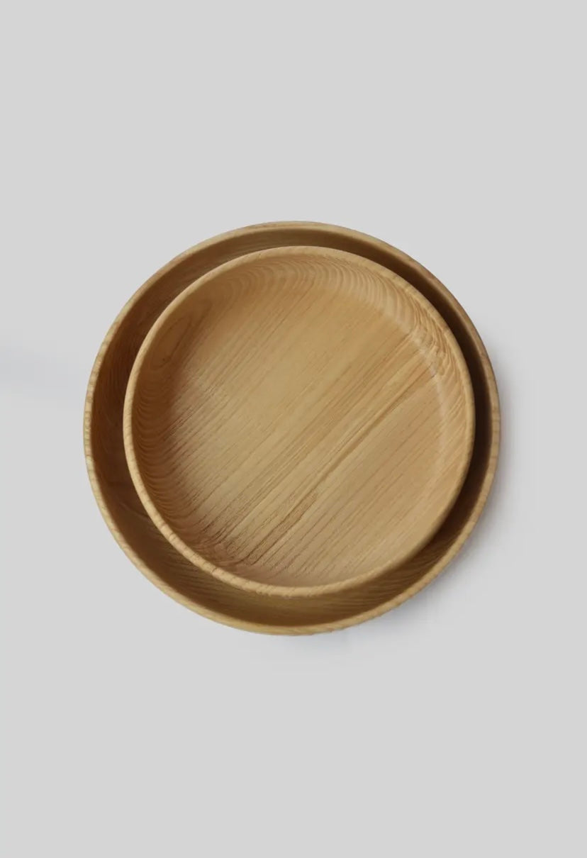 Two wooden catchal trays stacked on a light gray background