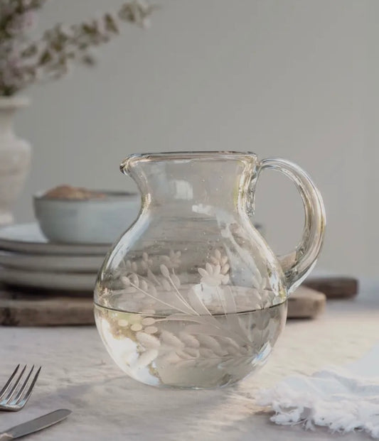 Close-up of 40 oz recycled glass pitcher showing detailed floral etching