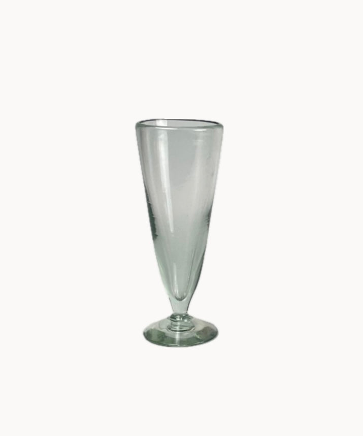 Close-up of artisan pilsner glass showing bubbles and tapering silhouette