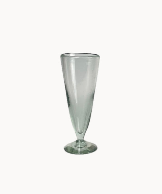 Close-up of artisan pilsner glass showing bubbles and tapering silhouette