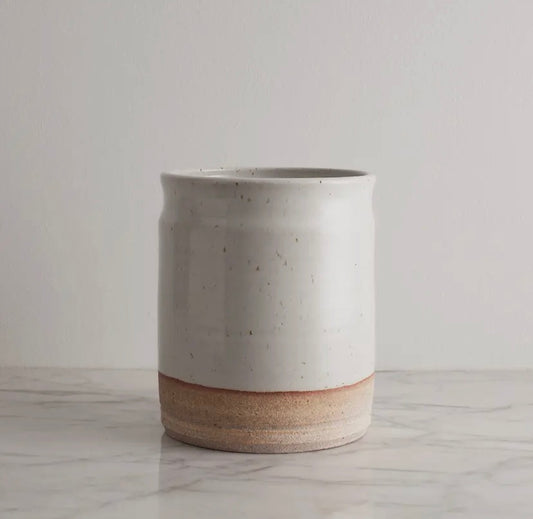 Minimalist ceramic utensil crock with natural texture and hand-thrown finish.