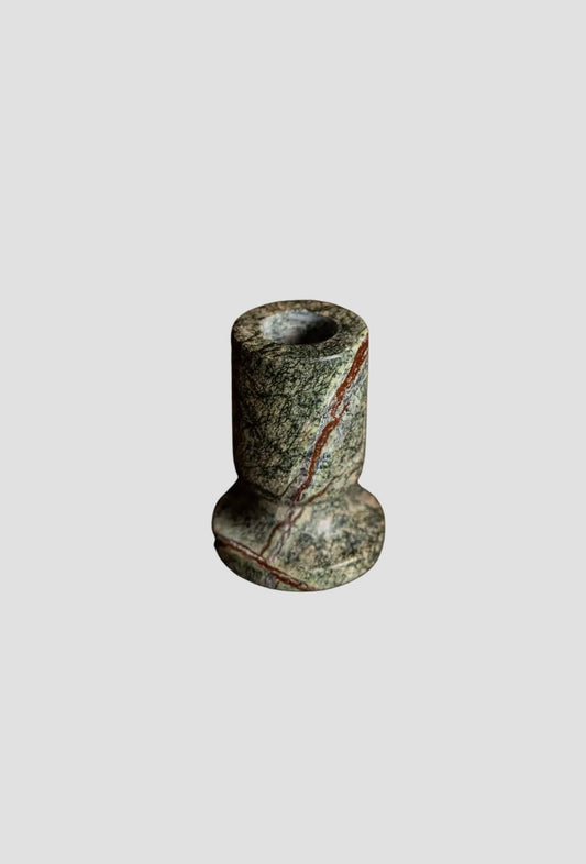 Green marble taper holder on a white background