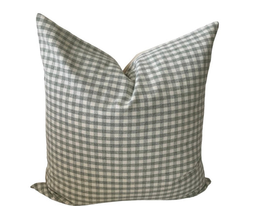 A square-shaped pillow cover with a checkered pattern in sage green and ivory colors, featuring a canvas back.