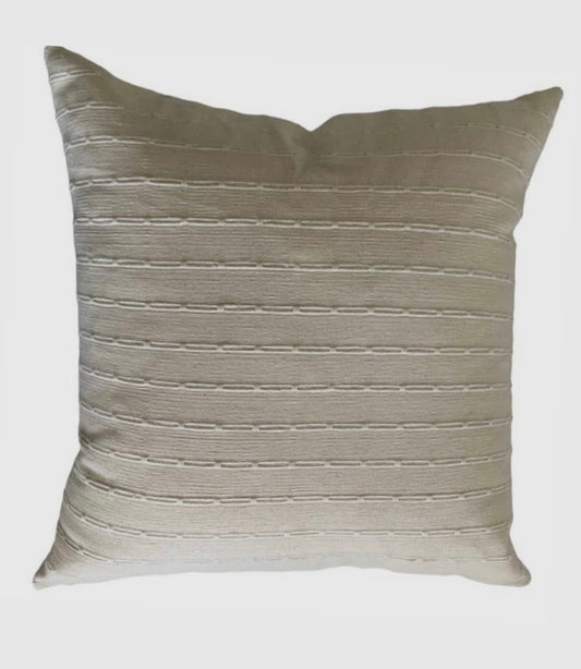 A minimalist cotton pillow cover with a subtle texture, featuring an ivory and natural color. The pillow cover is woven and has a rectangular shape with a cushioned texture.