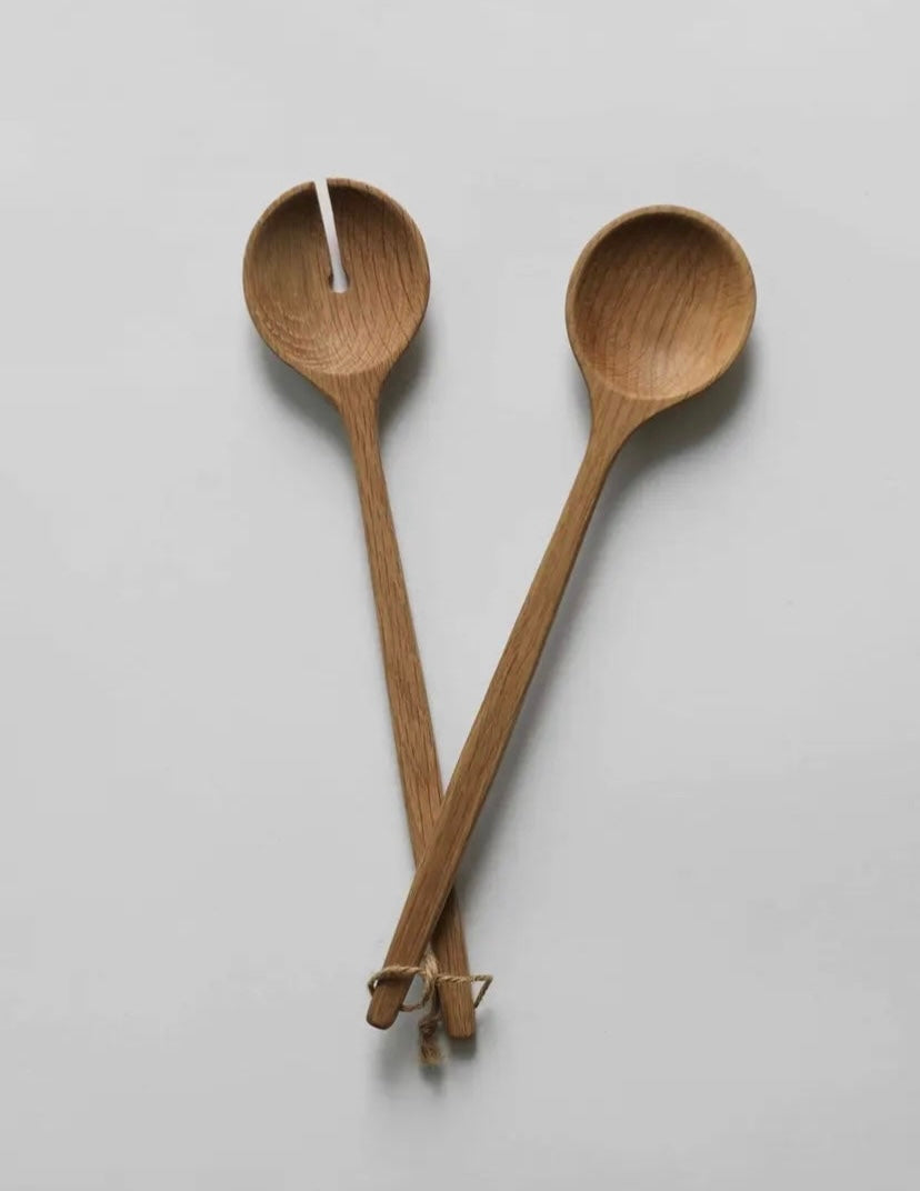 Two wooden spoons on a light gray background