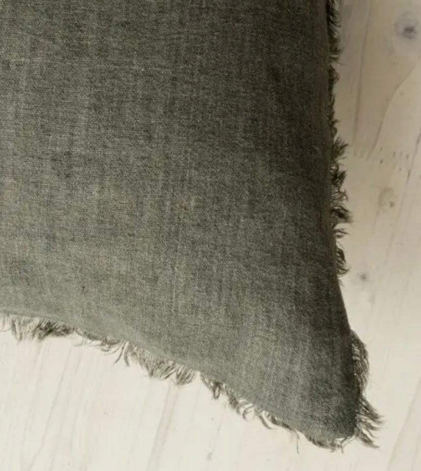 Textured fabric with frayed edges on a light background